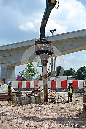 Retaining wall steel sheet pile installation by machine Editorial Stock Photo